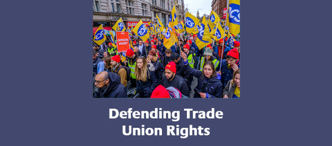 Defending Trade Union Rights - a large crowd of PCS members holding flags on a demo