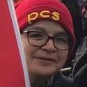 Paulette is wearing a red PCS beanie hat and glasses.